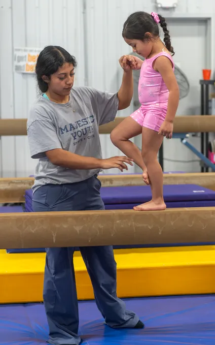 Toddlers enjoying safe gymnastics activities with colorful equipment
