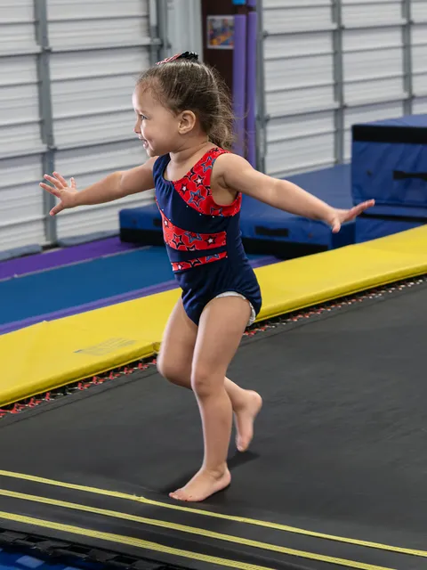 Happy toddlers exploring colorful gymnastics equipment in safe, age-appropriate setting