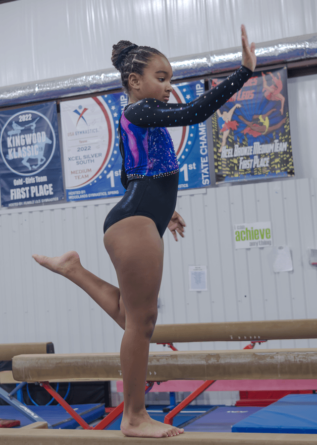Xcel gymnast performing a floor routine